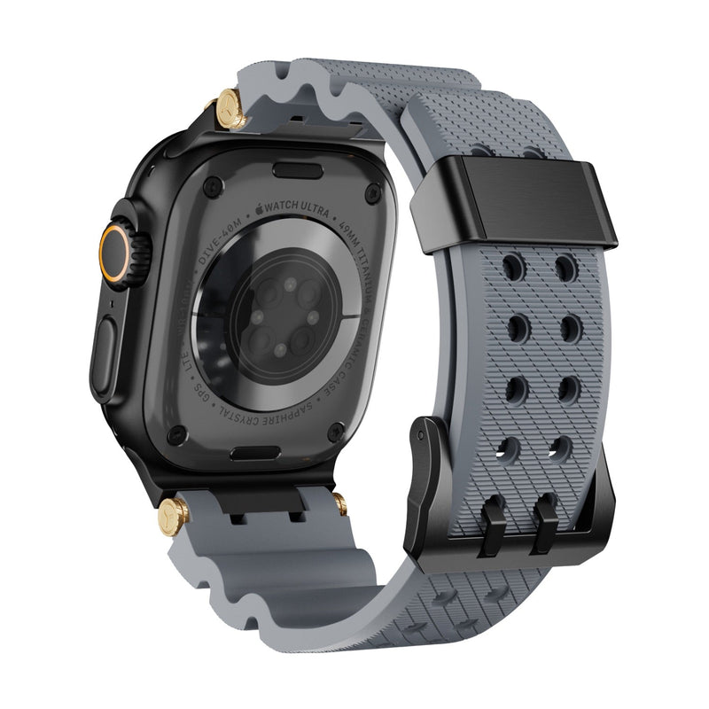 Bracelet silicone gris à détail or, design technique ajouré, boucle noire pour Apple Watch.