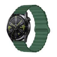 Montre connectée Huawei Watch avec bracelet silicone vert foncé ondulé et fermoir magnétique noir.