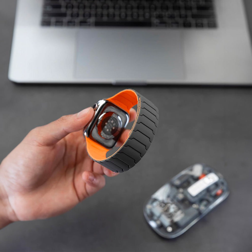 Bracelet silicone magnétique noir avec intérieur orange pour Apple Watch, design ajustable pro.