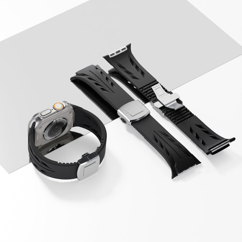 Bracelet silicone noir avec fermeture papillon argent pour Apple Watch, design ajouré et ajustable.