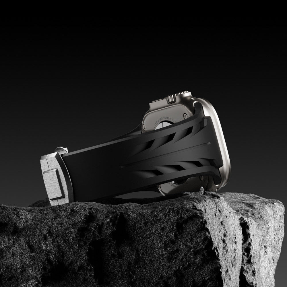 Bracelet en silicone noir texturé avec fermoir papillon argenté pour Apple Watch.