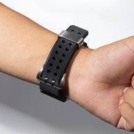 Bracelet en silicone noir perforé avec double ardillon argenté, ajustable pour Apple Watch.