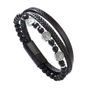 Bracelet multi-rangs noir en simili cuir avec perles noires et breloques arbre de vie en métal argenté.