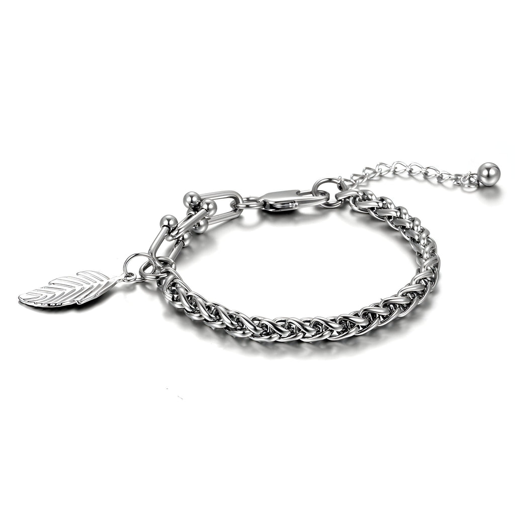 Bracelet en titane argenté avec maille spiga et charm plume élégante pour femme.