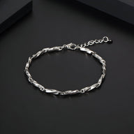 Bracelet homme en titane argenté à maille torsadée fine avec fermoir réglable sur fond noir.