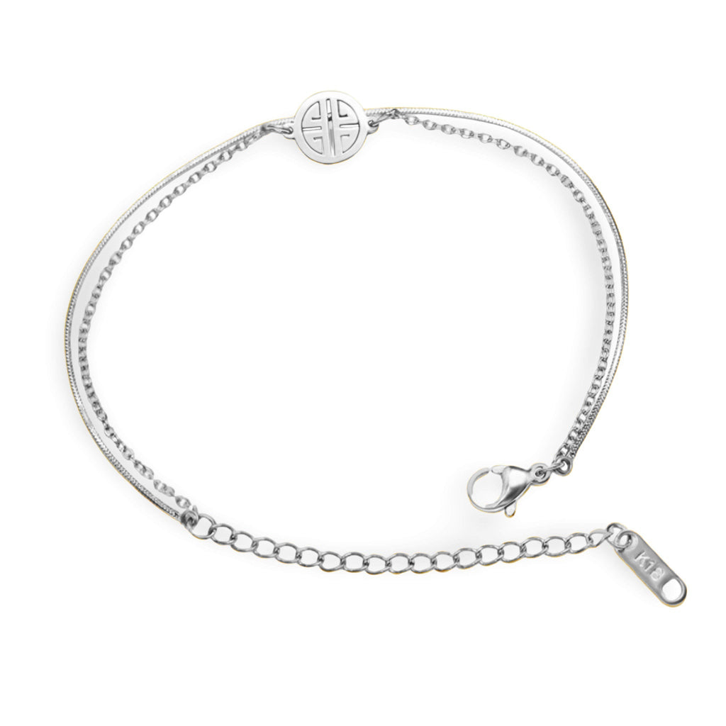 Bracelet en titane argenté avec chaîne fine et médaillon géométrique rond au fermoir mousqueton.