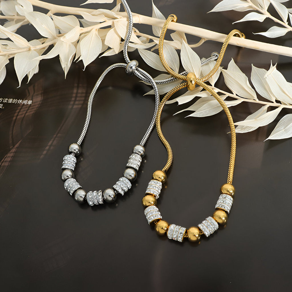 Bracelet en titane plaqué or avec perles dorées et pierres de cristal, modèle Nancy, variante or et argent.