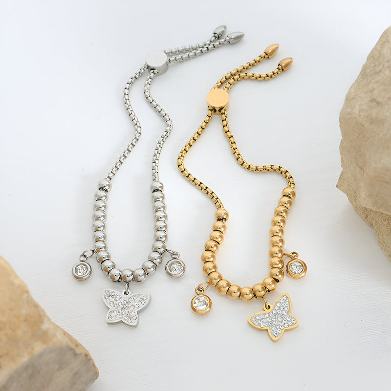 Bracelet en titane or avec médaillon papillon et pendant cristal, style chaîne billes.