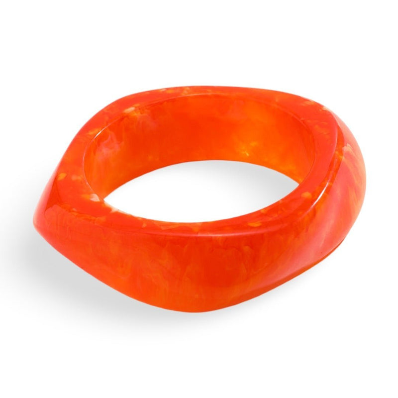 Bracelet épais en acrylique orange vif avec forme irrégulière et finition lisse.