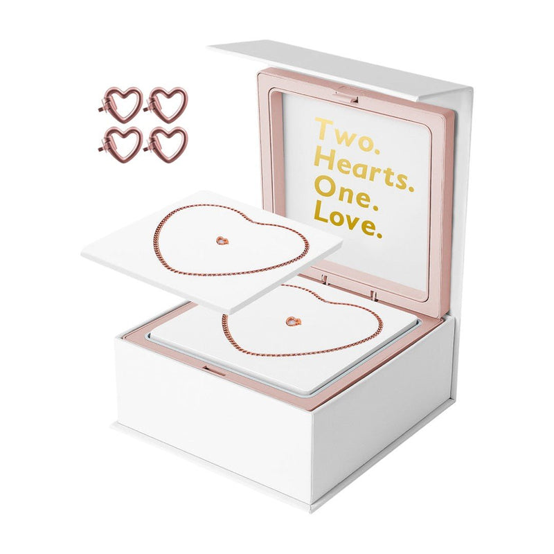 Bracelets en acier inoxydable argenté en forme de cœur, présentés dans un coffret blanc avec intérieur rose pâle et message.