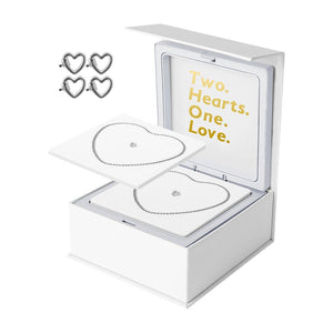 Bracelet éternel en acier inoxydable argenté en forme de cœur, coffret blanc avec message doré "Two Hearts. One. Love.".