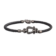 Bracelet femme cuir tressé noir avec fermoir en fer à cheval argenté orné de zircons brillants.