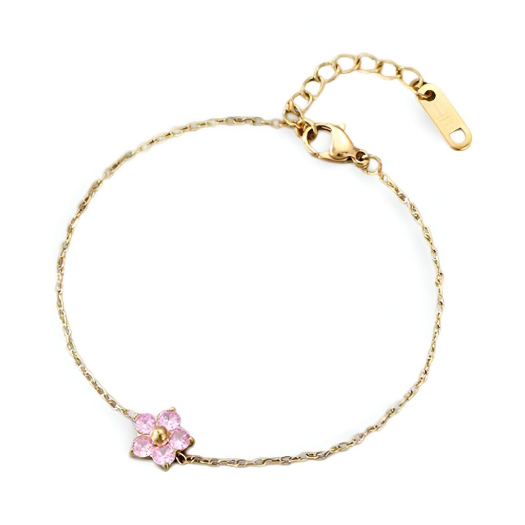Bracelet fin en acier inoxydable avec fleur rose délicate et détails dorés.