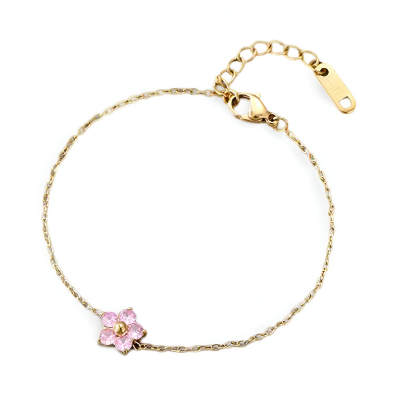 Bracelet fin en acier inoxydable avec fleur rose délicate et détails dorés.