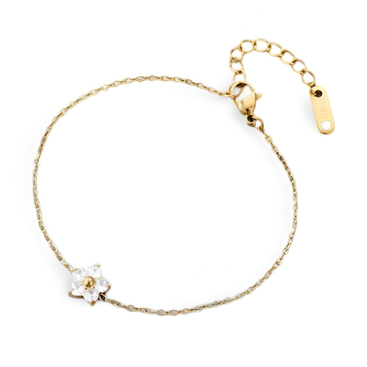 Bracelet fin en acier inoxydable avec petite fleur blanche et détail doré, chaîne délicate réglable.
