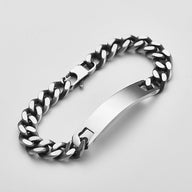 Bracelet gourmette en acier inoxydable anthracite avec plaque lisse et maillons larges et plats.