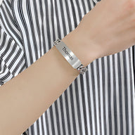 Bracelet gourmette en acier inoxydable argenté avec plaque personnalisée gravée "Thomas" sur maille spiga.