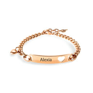 Bracelet gourmette or rosé en acier inoxydable avec plaque gravée "Alexia" et cœur découpé.