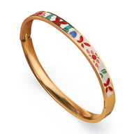 Bracelet jonc en métal doré avec motifs émaillés colorés rouge, bleu et vert style floral et géométrique.