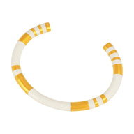 Bracelet jonc en titane blanc avec détails dorés rayés, modèle Bulie, élégant et coloré.