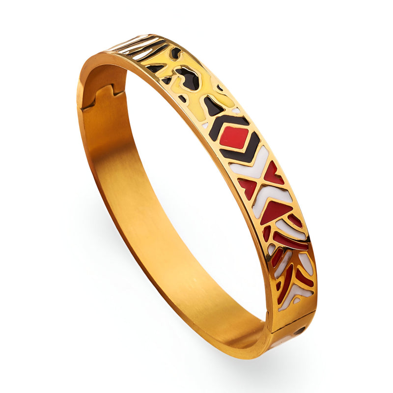 Bracelet jonc doré émaillé avec motifs géométriques rouges, noirs et blancs, finition lisse.