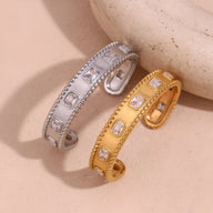 Bracelet jonc en acier inoxydable or orné de pierres carrées ajourées avec bords perlés, modèle Sohan et version argentée.