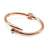 Bracelet jonc en acier inoxydable or rosé, design clou épuré et moderne pour femme.