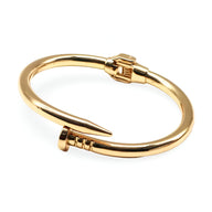 Bracelet jonc doré en acier inoxydable, design clou épuré, finition brillante.