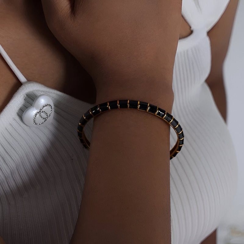 Bracelet jonc noir en titane et acrylique avec détails dorés, pour femme, modèle Hestia.