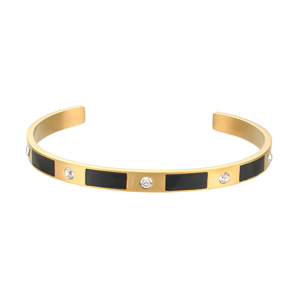 Bracelet jonc doré design géométrique avec rectangles noirs et trois strass brillants.