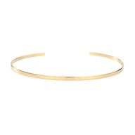 Bracelet jonc fin en acier inoxydable couleur or, finition lisse et brillante.