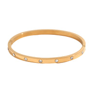 Bracelet jonc en acier inoxydable or, avec éclats de lumière incrustés uniformément.