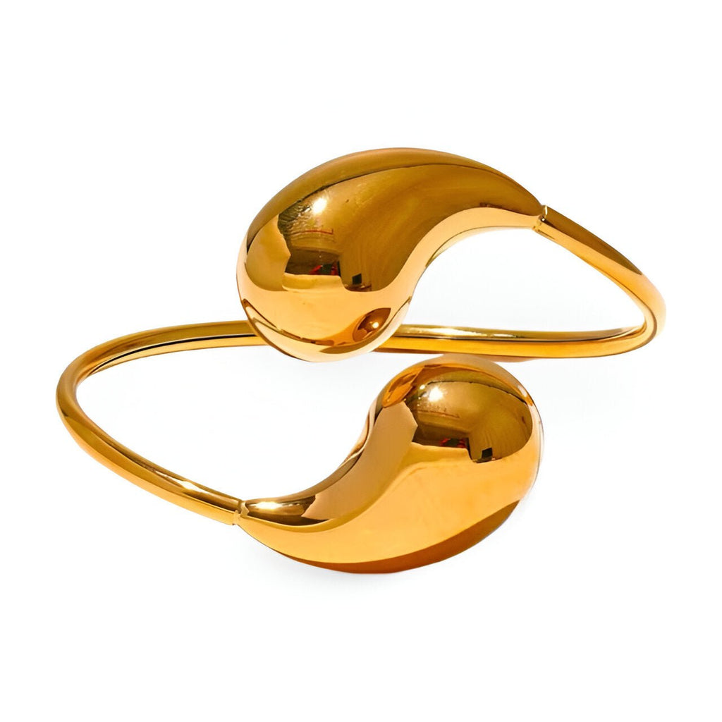 Bracelet jonc en acier inoxydable doré, design moderne avec extrémités bombées lisses.