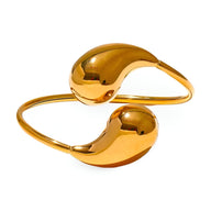 Bracelet jonc en acier inoxydable doré, design moderne avec extrémités bombées lisses.