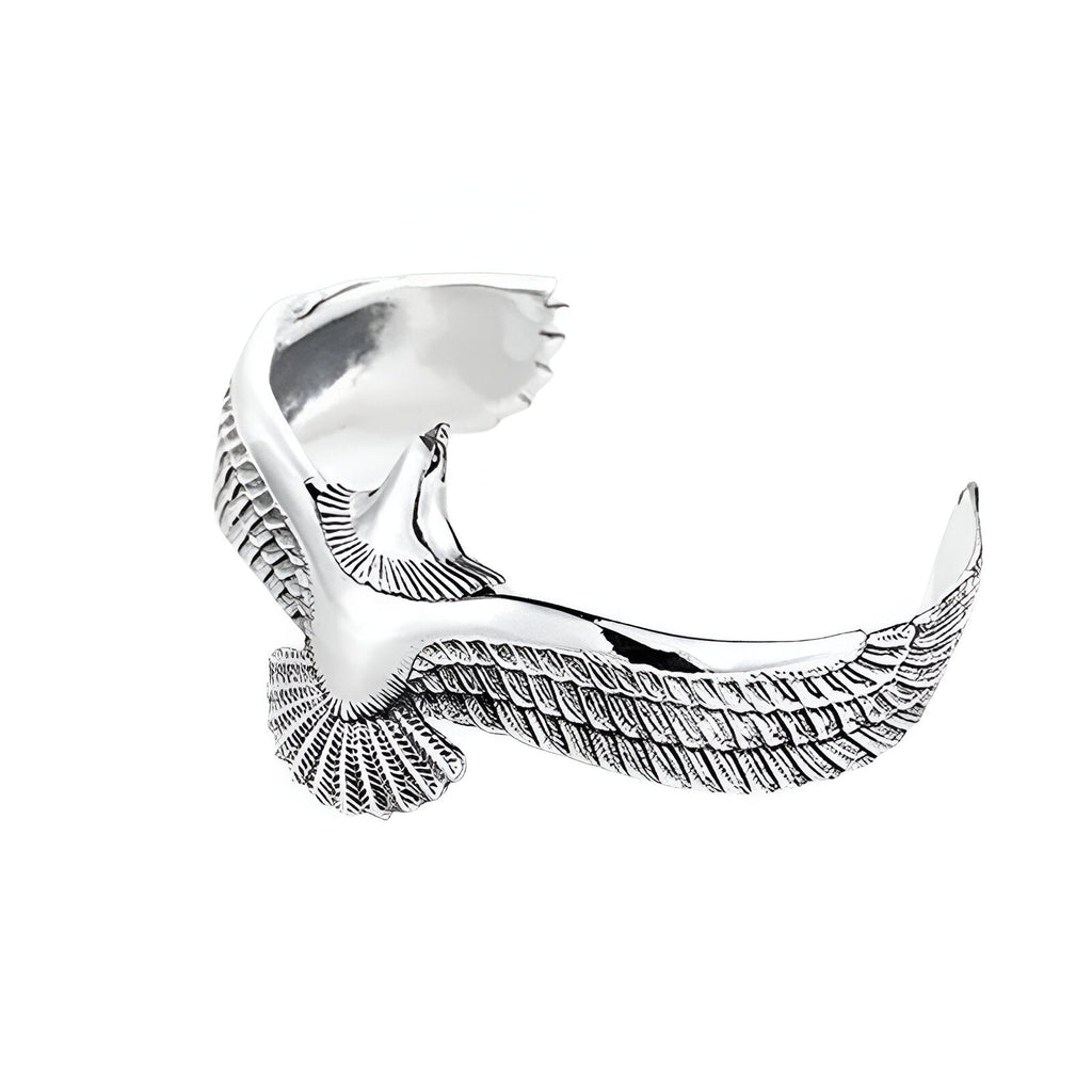 Bracelet jonc en titane argenté en forme d'aigle stylisé avec ailes déployées.
