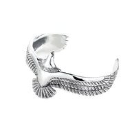 Bracelet jonc en titane argenté en forme d'aigle stylisé avec ailes déployées.