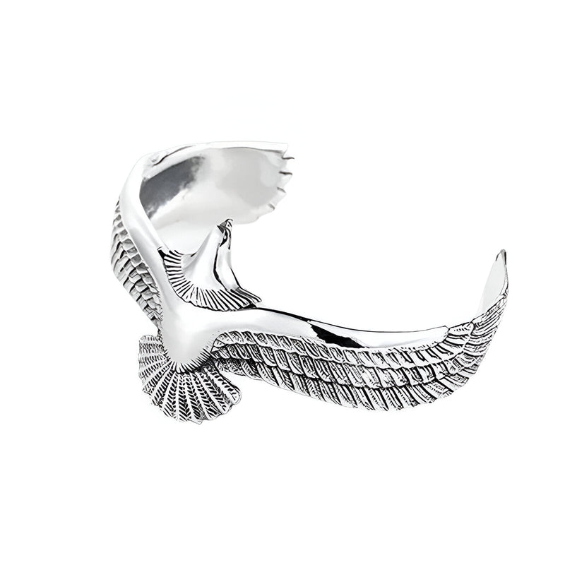 Bracelet jonc en titane argenté en forme d'aigle stylisé avec ailes déployées.