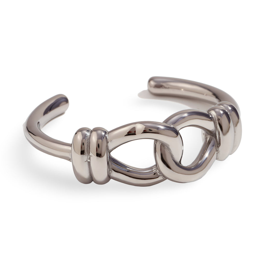 Bracelet jonc en acier inoxydable argenté avec nœud d'aigu sculpté design Cassiopée.