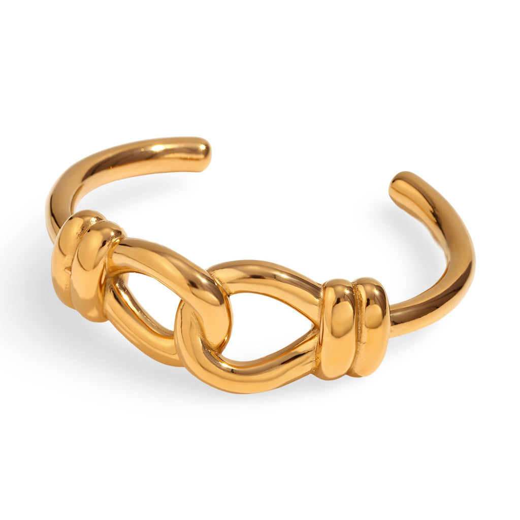 Bracelet jonc doré en acier inoxydable avec design de nœud d'agui élégant et lisse.