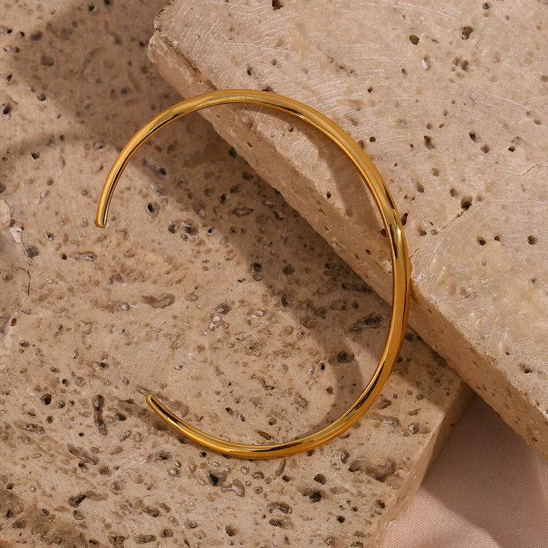 Bracelet jonc en acier inoxydable doré avec design ondulé élégant modèle Lyra.