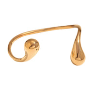 Bracelet jonc en acier inoxydable doré avec extrémités stylisées goutte et boule lisse.