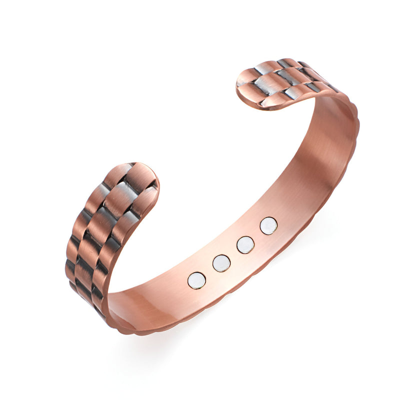 Bracelet jonc magnétique en cuivre bronze avec design tressé et aimants visibles à l’intérieur.