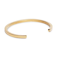 Bracelet jonc fin en acier inoxydable doré, design minimaliste pour homme et femme.