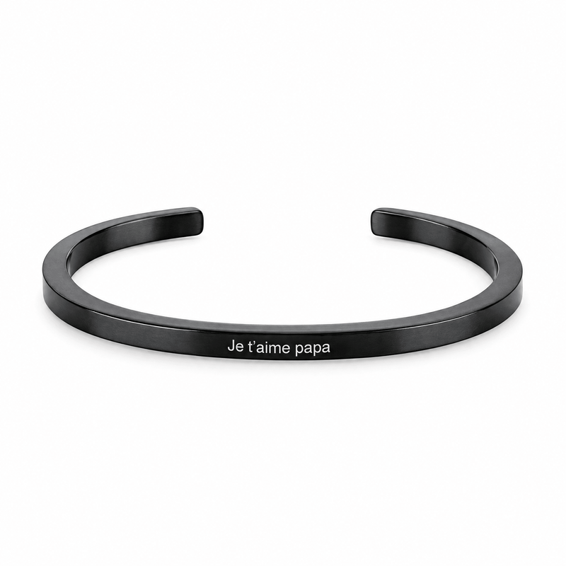 Bracelet jonc Vicky noir, gravure personnalisée Je t’aime papa, posé de face sur fond blanc