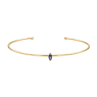 Bracelet jonc fin en acier inoxydable doré avec petite pierre bleue marquise centrale.