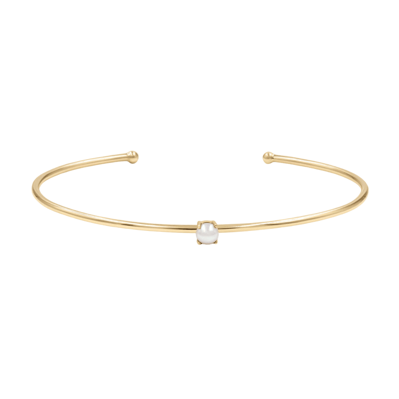 Bracelet jonc fin doré en acier inoxydable avec petite pierre blanche centrale, style discret Adéni.