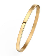 Bracelet jonc fin en titane plaqué or 18 carats, finition lisse et brillante.