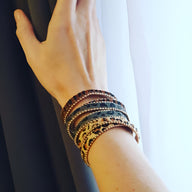 Bracelet léopard en microfibre marron avec plusieurs tours et motifs animaux sur poignet féminin.