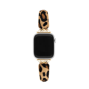 Bracelet fin effet poils léopard beige et noir avec attaches dorées pour Apple Watch.