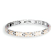 Bracelet magnétique en titane pour femme, design argenté avec motifs croisés or rosé, finition lisse.